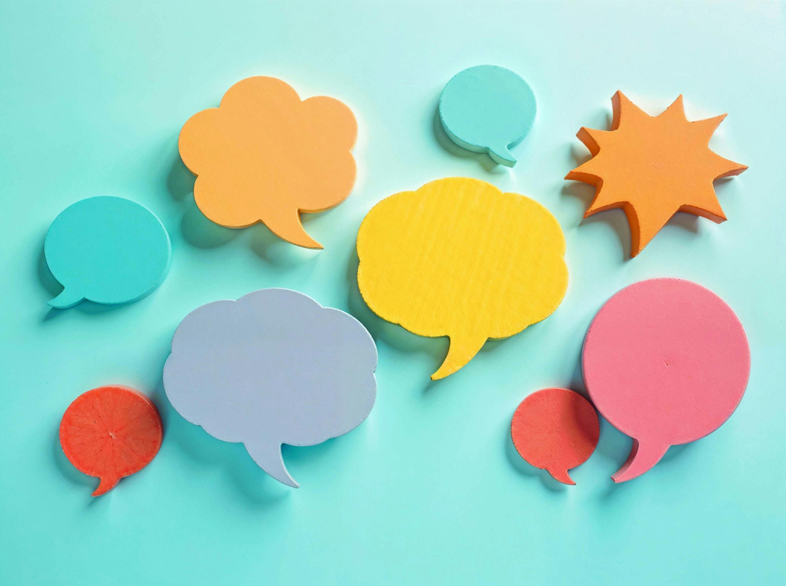 Colorful speech bubble-shaped objects on a light blue background